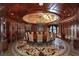 Opulent dining room boasting rich wood paneling, a decorative floor and ceiling, and an elegant chandelier at 9101 Alta Dr # 1203, Las Vegas, NV 89145
