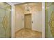 Elevator with decorative glass doors and chandelier, offering a glimpse of sophisticated design and functionality at 9101 Alta Dr # 1203, Las Vegas, NV 89145