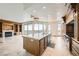 Open kitchen and living space featuring a center island, cooktop, fireplace and access to a balcony at 9101 Alta Dr # 1203, Las Vegas, NV 89145