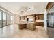 Bright open kitchen with a center island, custom cabinets, stainless steel appliances, and balcony access at 9101 Alta Dr # 1203, Las Vegas, NV 89145