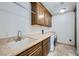 This laundry room includes a sink with granite countertops, cabinets, and a washer and dryer at 9101 Alta Dr # 1203, Las Vegas, NV 89145