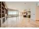 Open-concept living area with built-in shelving, fireplace, balcony, and views, showcasing a sophisticated and upscale design at 9101 Alta Dr # 1203, Las Vegas, NV 89145