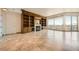 Spacious living room with built-in bookcase, fireplace, and balcony access, showcasing luxury living and natural light at 9101 Alta Dr # 1203, Las Vegas, NV 89145
