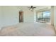 Spacious primary bedroom with plush carpet, a ceiling fan, and access to a balcony with wrought iron details at 9101 Alta Dr # 1203, Las Vegas, NV 89145