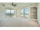 Bright primary bedroom featuring a ceiling fan, neutral carpet, oversized windows with amazing outdoor views and balcony access at 9101 Alta Dr # 1203, Las Vegas, NV 89145