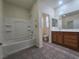 Bathroom featuring a bathtub and a wood vanity with double sinks, creating a functional space at 9312 Gold Dove Ct, Las Vegas, NV 89178