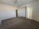 A spacious bedroom with carpeted flooring, two closets, and an ensuite bathroom offering convenience at 9312 Gold Dove Ct, Las Vegas, NV 89178