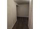 Narrow hallway featuring neutral walls, carpet, and access to additional storage space at 9312 Gold Dove Ct, Las Vegas, NV 89178