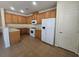 Traditional kitchen with tile floors, wood cabinets and white appliances at 9312 Gold Dove Ct, Las Vegas, NV 89178
