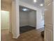 Open living room featuring tile flooring, neutral walls, and an open doorway to a carpeted room at 9312 Gold Dove Ct, Las Vegas, NV 89178