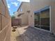 Cozy brick patio with a sliding glass door for indoor/outdoor living and desert landscaping at 9312 Gold Dove Ct, Las Vegas, NV 89178