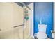 Clean bathroom features tiled shower with glass door, toilet, and vanity at 10373 Hawk Ravine St, Las Vegas, NV 89178