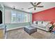 Cozy bedroom features carpet, shutters, TV, and comfortable seating at 10373 Hawk Ravine St, Las Vegas, NV 89178