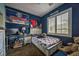 Cozy bedroom features a twin bed, desk, and window with plantation shutters at 10373 Hawk Ravine St, Las Vegas, NV 89178