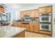 Gourmet kitchen with stainless steel appliances, double ovens, and custom cabinets at 10373 Hawk Ravine St, Las Vegas, NV 89178