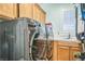 Functional laundry room showcasing modern washer and dryer with built-in cabinets at 10373 Hawk Ravine St, Las Vegas, NV 89178