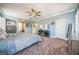 Large main bedroom with carpet flooring, plantation shutters, and TV at 10373 Hawk Ravine St, Las Vegas, NV 89178