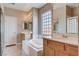 Bright bathroom with double sinks, a soaking tub, large window, and vanity at 1127 Lake Berryessa St, Henderson, NV 89002