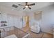 Bedroom with white walls, modern crib, chair and boho-themed decor at 1127 Lake Berryessa St, Henderson, NV 89002