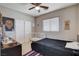 Neutral bedroom with large window, ceiling fan, dresser, closet, and a bed at 1127 Lake Berryessa St, Henderson, NV 89002