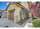 Charming home detail with stucco siding, three car garage, and verdant landscaping at 1127 Lake Berryessa St, Henderson, NV 89002
