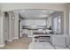Bright kitchen features white cabinets, dark counters, backsplash, stainless appliances, and an eat-in kitchen island at 1127 Lake Berryessa St, Henderson, NV 89002