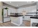 Bright kitchen features white cabinets, dark counters, backsplash, stainless appliances, and an eat-in kitchen island at 1127 Lake Berryessa St, Henderson, NV 89002