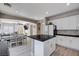Bright kitchen features white cabinets, dark counters, backsplash, stainless appliances, and an eat-in kitchen island at 1127 Lake Berryessa St, Henderson, NV 89002