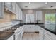 Bright kitchen features white cabinets, dark counters, backsplash, stainless appliances, and an eat-in kitchen island at 1127 Lake Berryessa St, Henderson, NV 89002