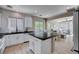 Bright kitchen features white cabinets, dark counters, backsplash, stainless appliances, and an eat-in kitchen island at 1127 Lake Berryessa St, Henderson, NV 89002