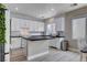 Bright kitchen features white cabinets, dark counters, backsplash, stainless appliances, and an eat-in kitchen island at 1127 Lake Berryessa St, Henderson, NV 89002