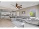Open-concept living room features a modern ceiling fan, seamlessly connecting to the dining area and kitchen at 1127 Lake Berryessa St, Henderson, NV 89002