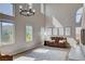 Bright living room featuring high ceilings, ample natural light, and elegant chandelier lighting at 1127 Lake Berryessa St, Henderson, NV 89002