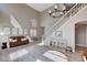 Airy living room featuring high ceilings, a staircase and comfortable seating area at 1127 Lake Berryessa St, Henderson, NV 89002