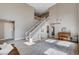 Elegant living room with a two-story ceiling, light floors and a graceful staircase at 1127 Lake Berryessa St, Henderson, NV 89002