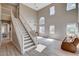 Bright living room with two-story ceilings, large windows, and elegant staircase at 1127 Lake Berryessa St, Henderson, NV 89002