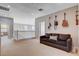 Upstairs loft area with a couch, guitars hung on the wall, and neutral colored carpet at 1127 Lake Berryessa St, Henderson, NV 89002