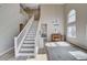 Grand staircase with bright white banisters leading to the upper level, complemented by high ceilings and natural light at 1127 Lake Berryessa St, Henderson, NV 89002