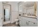 Clean bathroom featuring granite counters, white cabinetry, and modern fixtures at 12110 Midnight Pine Rd # 4, Las Vegas, NV 89183
