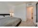 Bedroom with a neutral color scheme and doorway view to an ensuite bath at 12110 Midnight Pine Rd # 4, Las Vegas, NV 89183