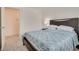 Bedroom featuring a soft bed, side tables, and a view into an ensuite bathroom at 12110 Midnight Pine Rd # 4, Las Vegas, NV 89183