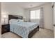 Bright bedroom with a comfortable bed, side tables, and neutral-toned curtains at 12110 Midnight Pine Rd # 4, Las Vegas, NV 89183
