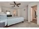 Well-lit bedroom boasts a ceiling fan and doorway to the bathroom at 12110 Midnight Pine Rd # 4, Las Vegas, NV 89183