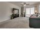 Open living room with plush carpet, modern furnishings, and a sliding glass door at 12110 Midnight Pine Rd # 4, Las Vegas, NV 89183