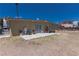 Backyard featuring a concrete patio, fence, and a building with a security door at 1312 Denarius Cir, Las Vegas, NV 89101