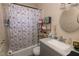 Bathroom featuring a patterned shower curtain, vanity, and a round mirror at 1312 Denarius Cir, Las Vegas, NV 89101