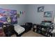 Bedroom featuring a daybed, aquarium, and colorful wall decorations at 1312 Denarius Cir, Las Vegas, NV 89101