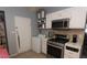 Compact kitchen equipped with stainless steel appliances and convenient white cabinetry at 1312 Denarius Cir, Las Vegas, NV 89101