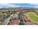 Picturesque aerial view showcasing houses situated near a golf course with mountains in the distance at 1343 Panini Dr, Henderson, NV 89052