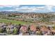 Beautiful aerial view of homes in a neighborhood near a golf course with mountains in the distance at 1343 Panini Dr, Henderson, NV 89052
